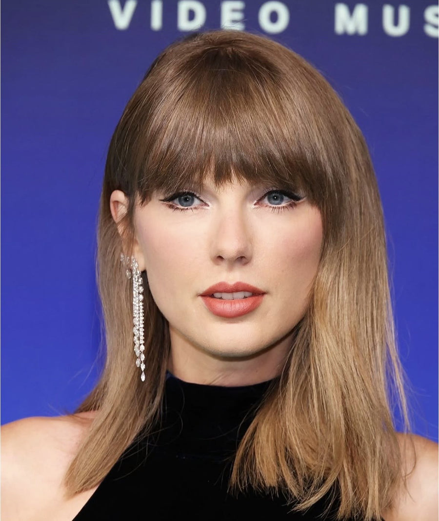 Editorial portrait of a woman with dark hair against a light background