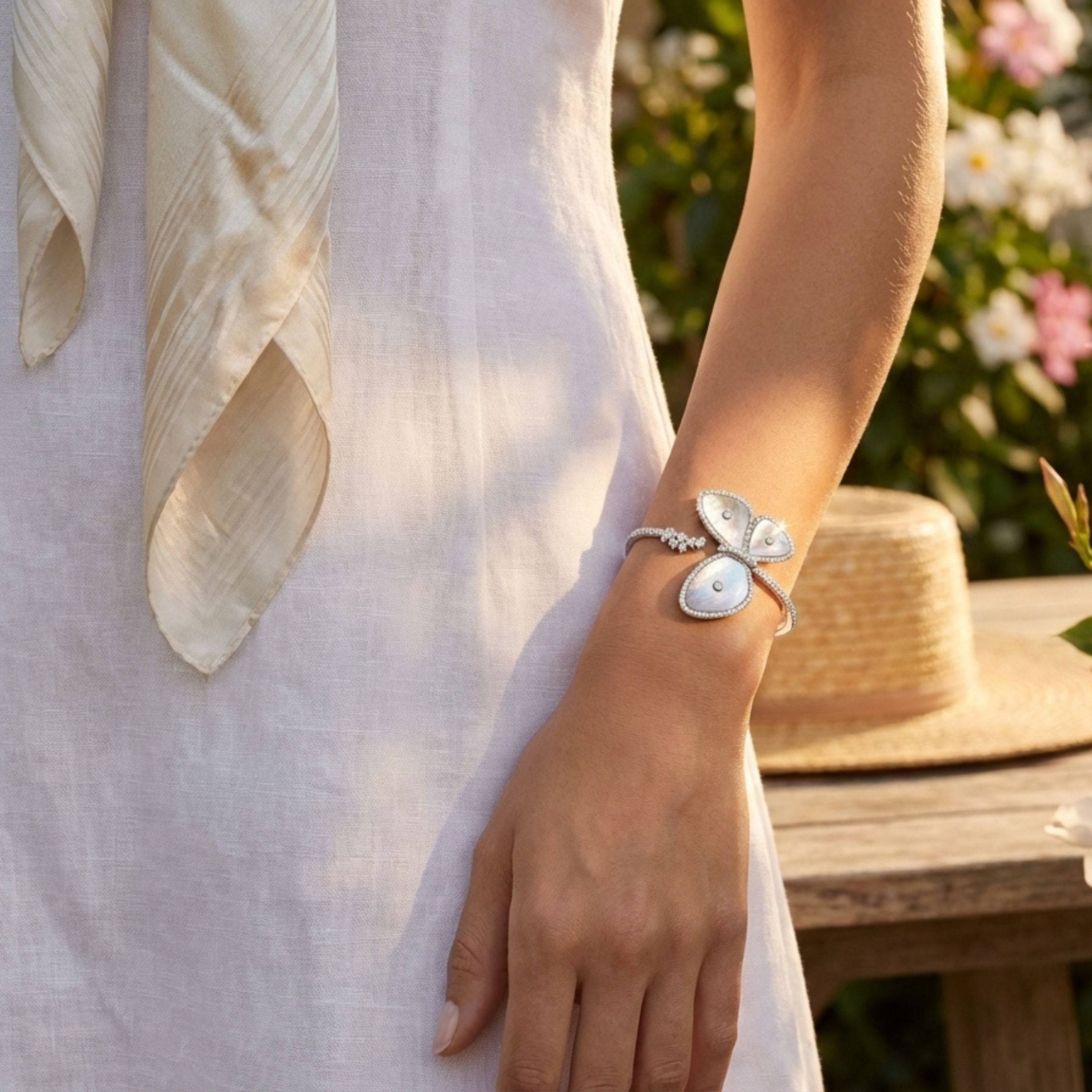 Asymmetrical Leviev butterfly bracelet featuring pearlescent wings and pavé diamond accents