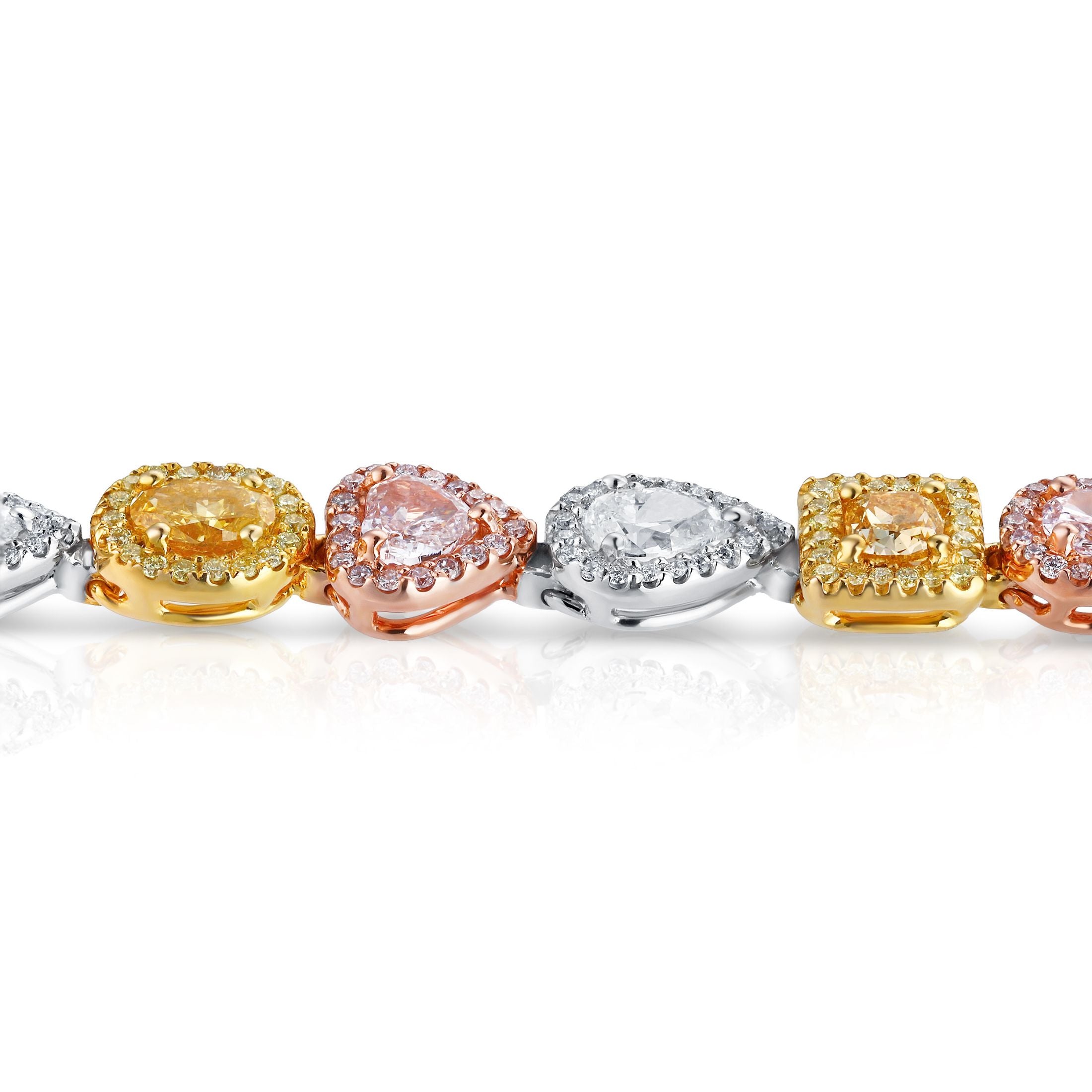 Close-up of mixed-metal gold links with pavé halo set round and pear diamonds