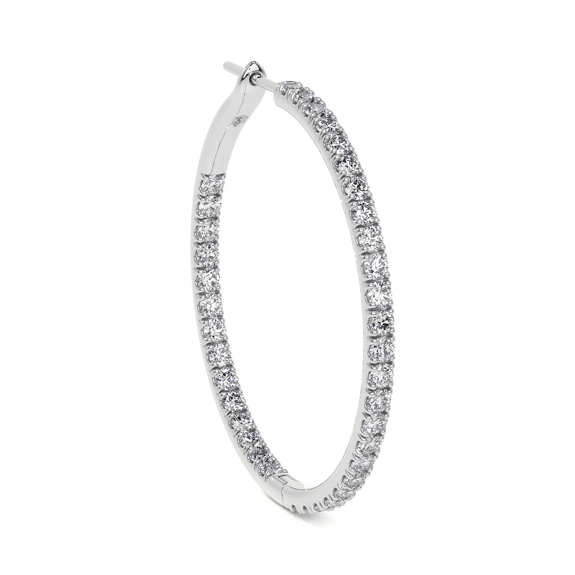 Diagonal angle of 32mm oval diamond hoop earrings highlighting polished interior and dense diamond row