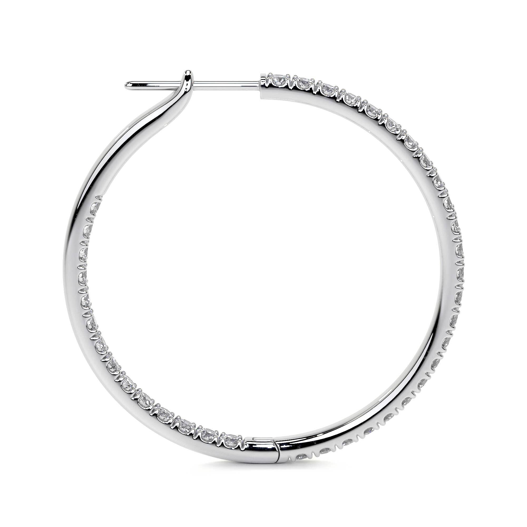 Side view of 32mm diamond hoop earrings with channel-set natural diamonds in 18K white gold