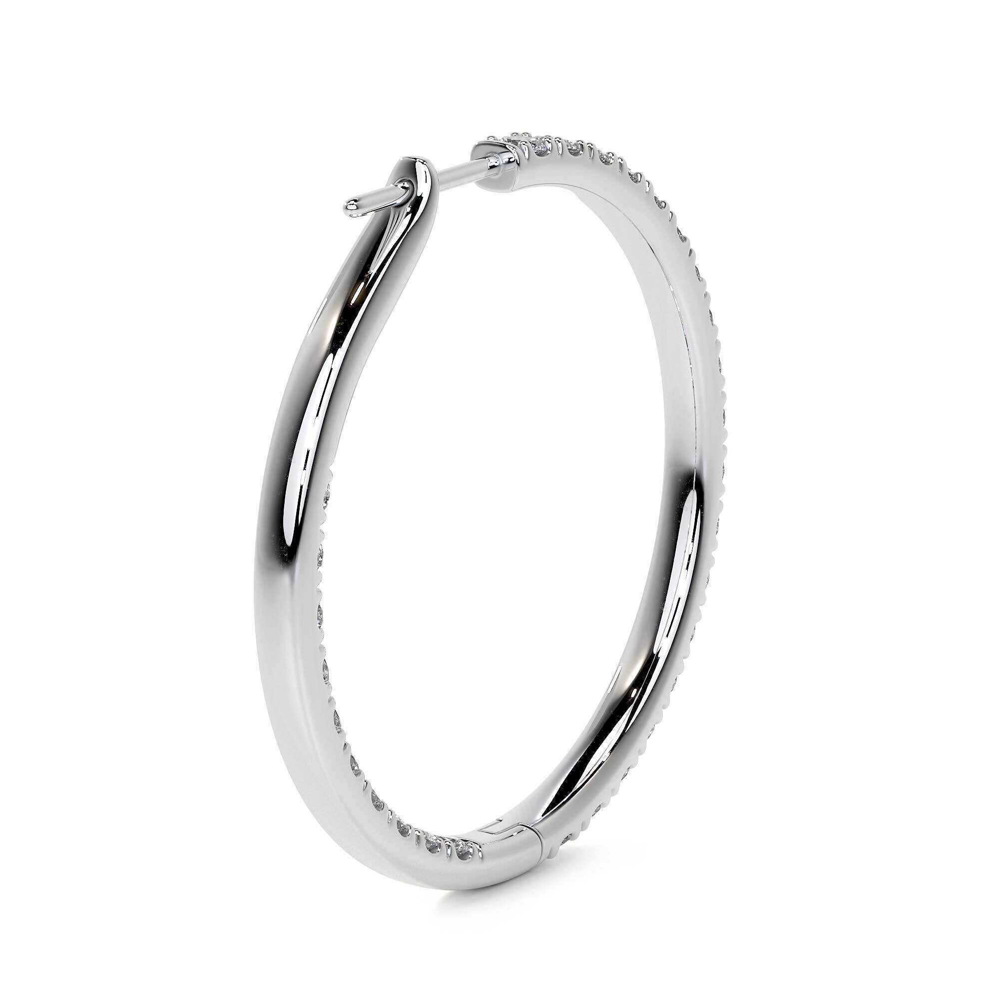 Angled detail of 32mm white gold diamond hoops showing seamless channel setting and polished band