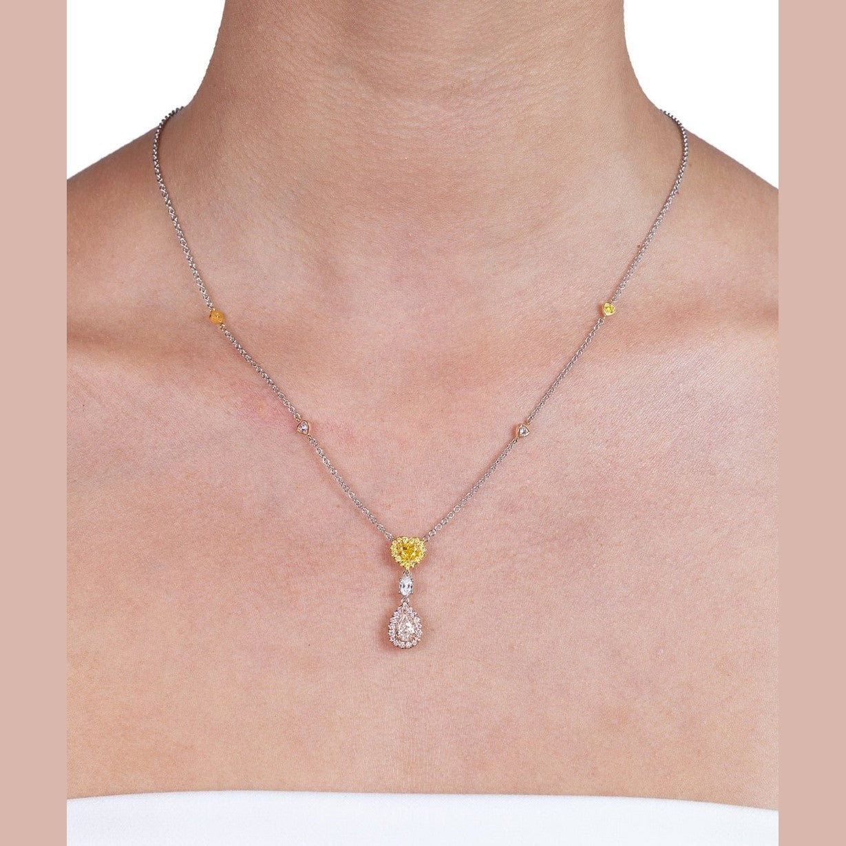 Marquise clear diamond and pear white diamond halo pendant with yellow accents