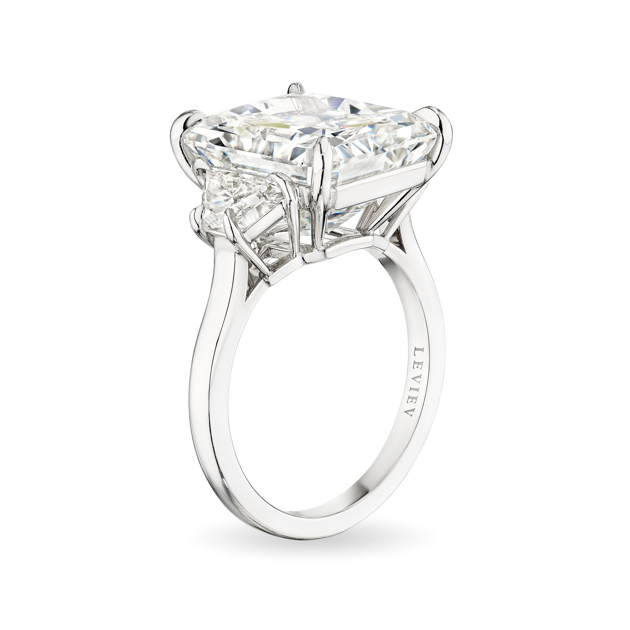 Leviev platinum solitaire ring with cushion-cut diamond and baguette shoulders showing engraved brand name