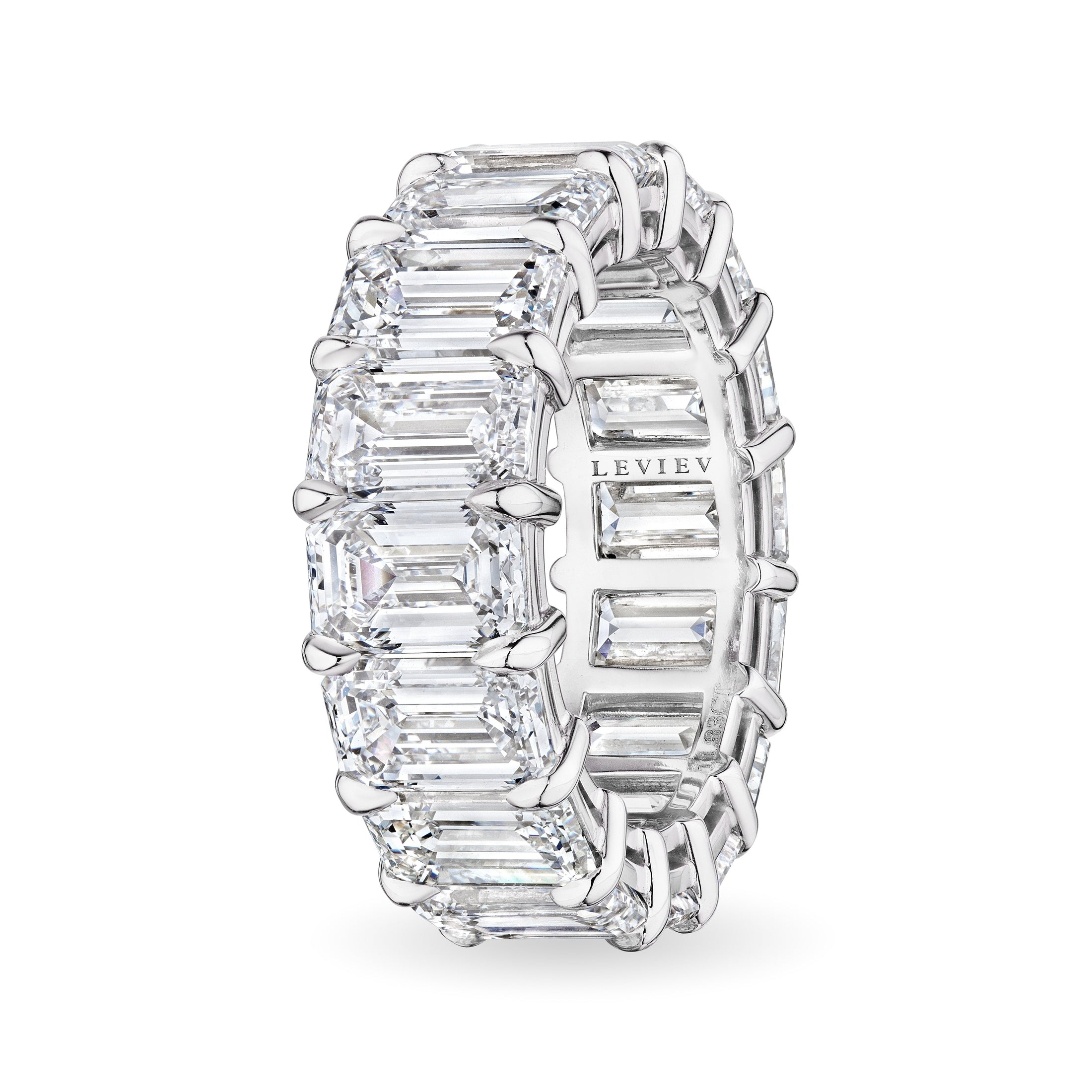 Side view Leviev platinum ring featuring claw-set emerald cut diamonds