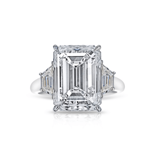 Platinum emerald cut diamond ring with tapered baguettes and step-cut facets