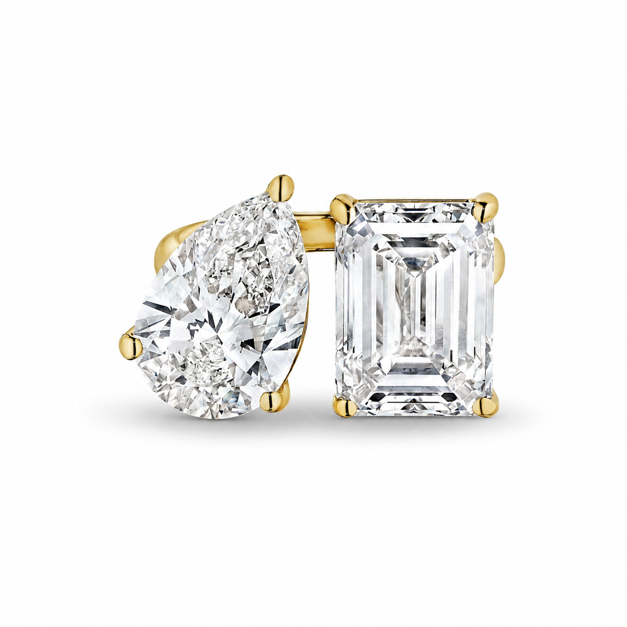Close-up of Estelle bypass ring with pear and radiant diamonds in 14K yellow gold