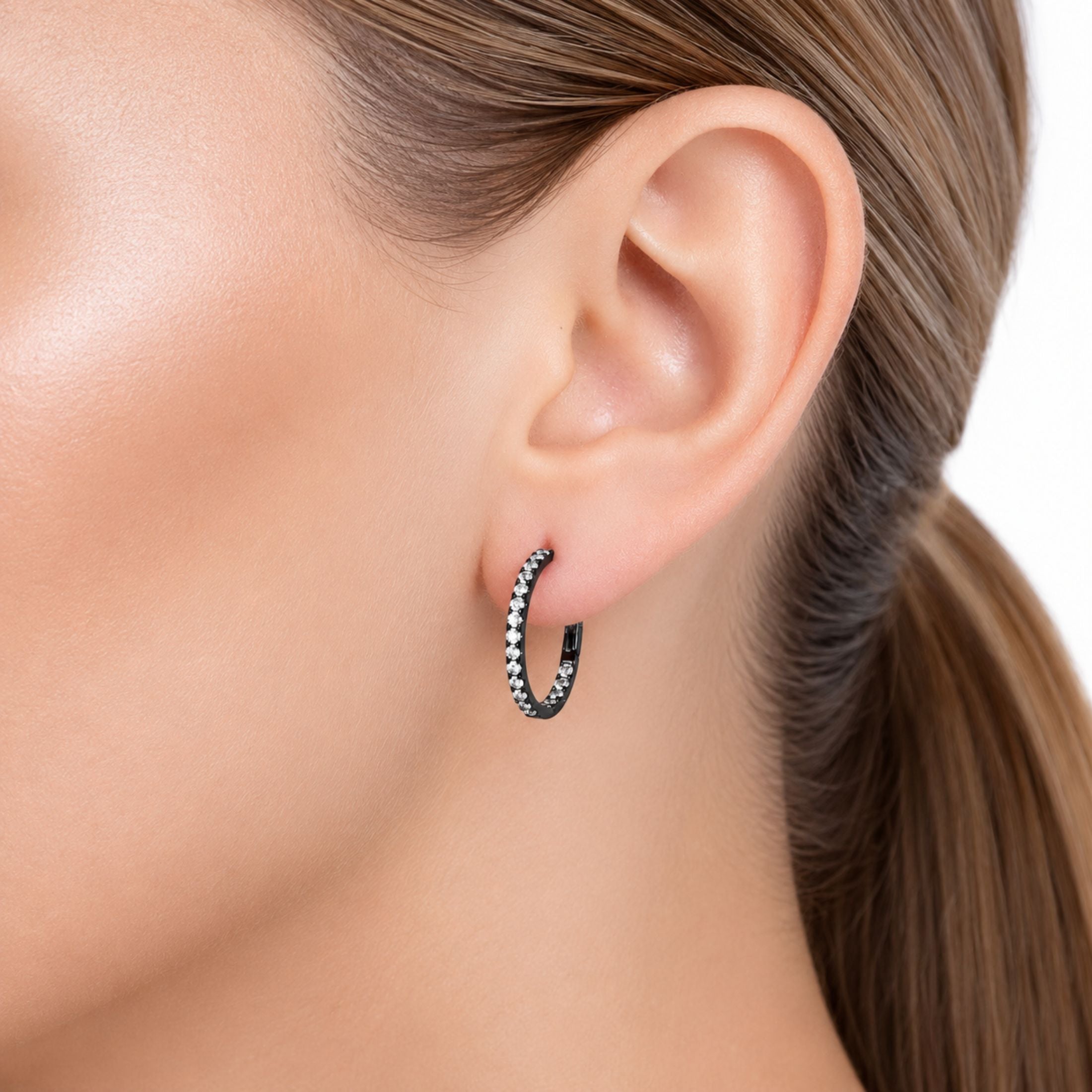 Black rhodium diamond hoop earrings worn on ear showing lightweight everyday fit