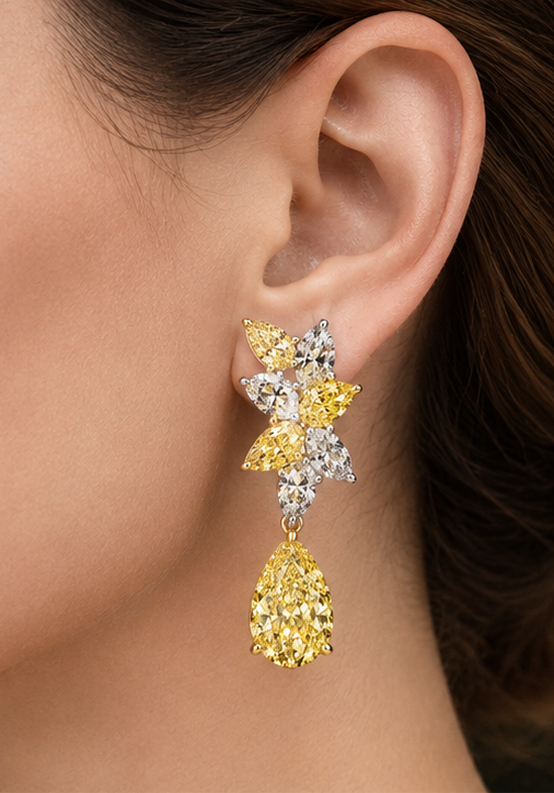 Hale yellow and white diamond drop earring worn on the ear, featuring marquise-cut diamond clusters and a yellow pear-shaped drop