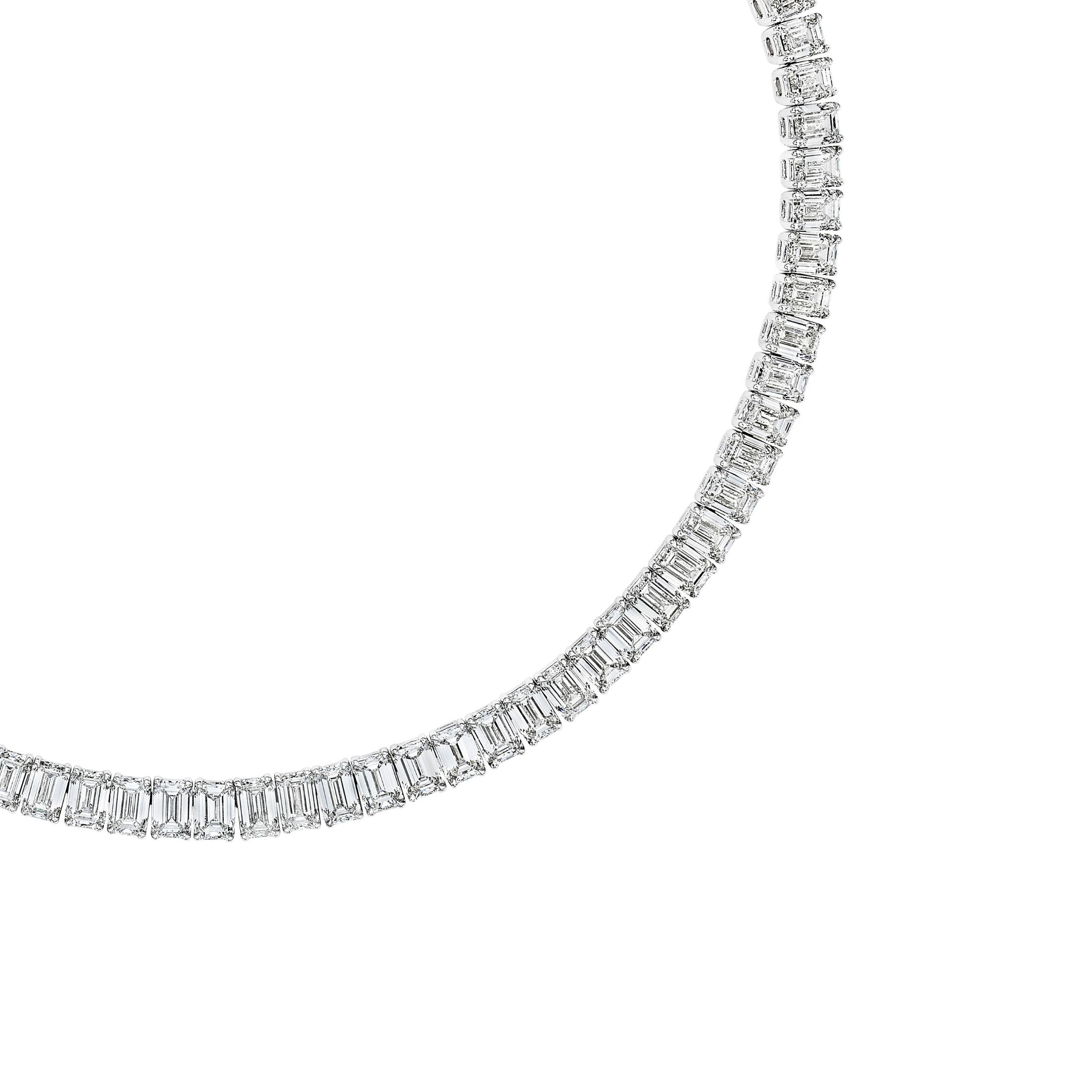 Close-up emerald-cut and round diamond detail on white gold necklace