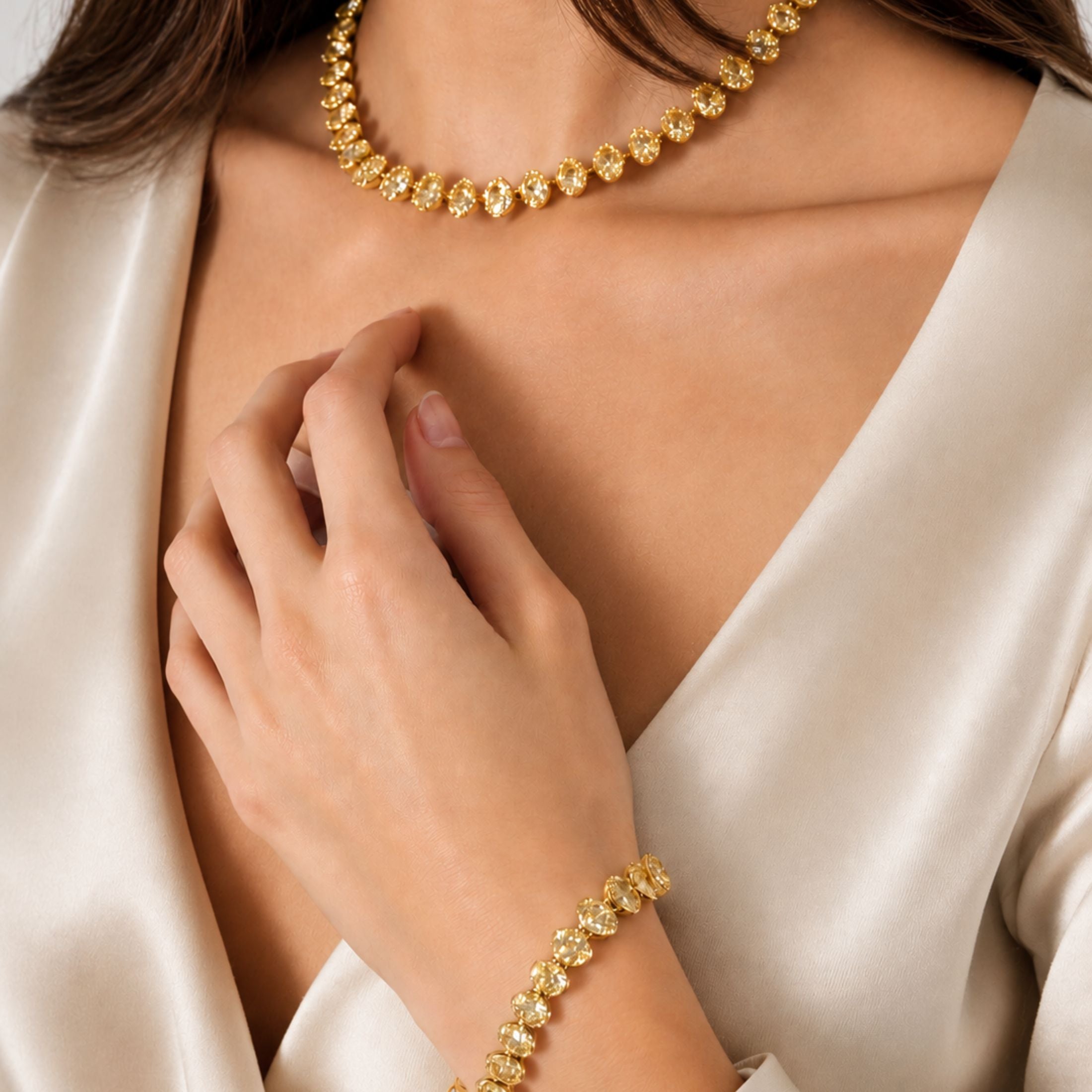 Woman wearing Leviev Luminara yellow diamond tennis bracelet and matching necklace set