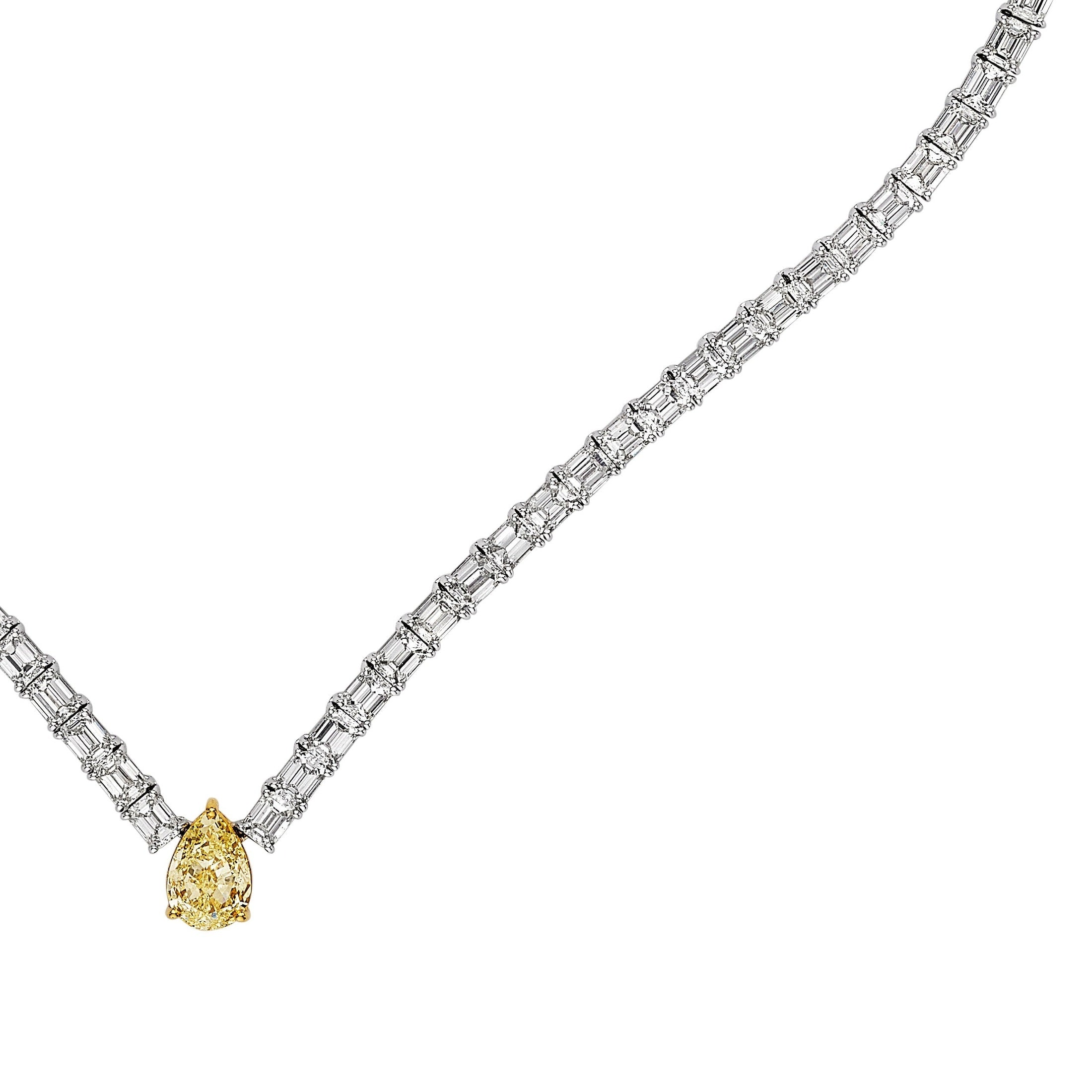 Close-up of channel-set baguette white diamonds and four-prong set pear yellow diamond on Luminary Whisper necklace