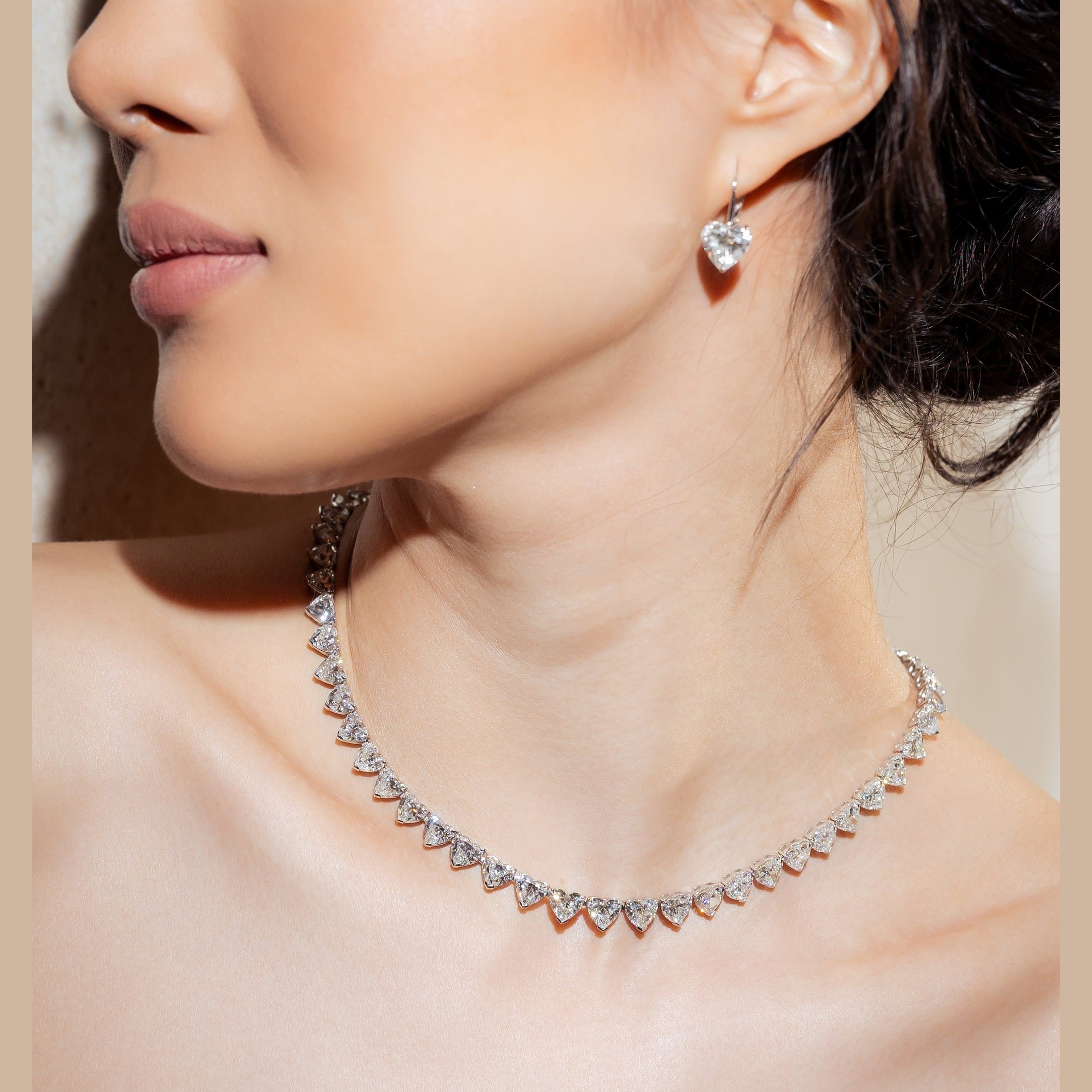 Close-up of silver-toned heart diamond necklace scalloped choker fit with earring