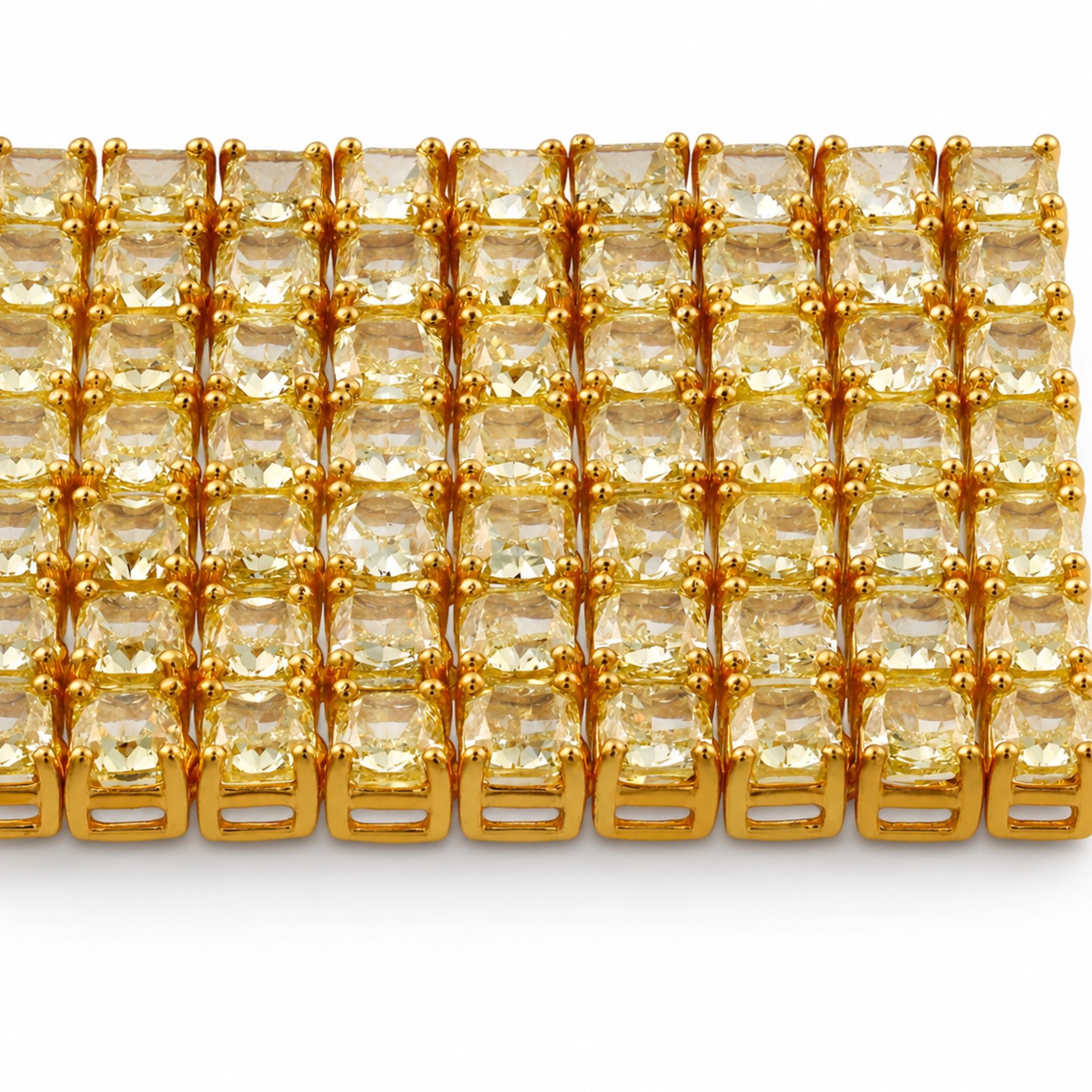 Close-up of Marques Riscal bracelet showing buttery yellow cushion-cut diamonds in four-prong gold setting with brushed metal texture