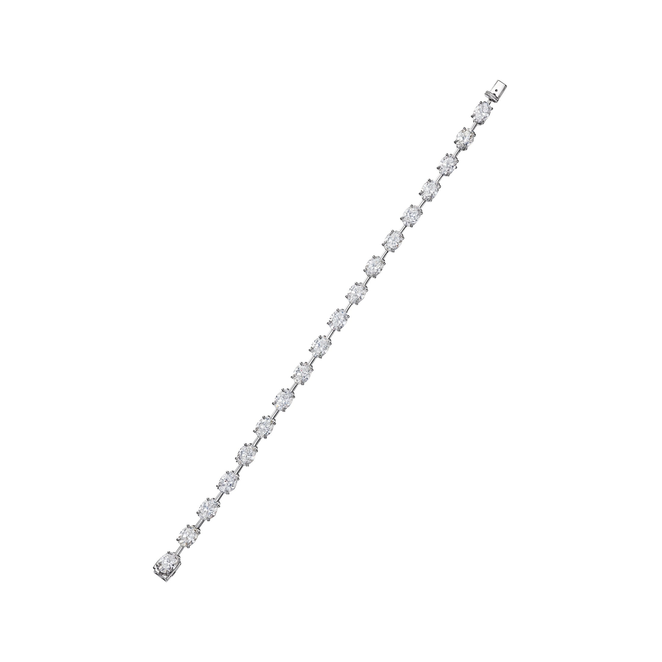 Full length platinum oval cut diamond station bracelet with tapered design and mirror finish