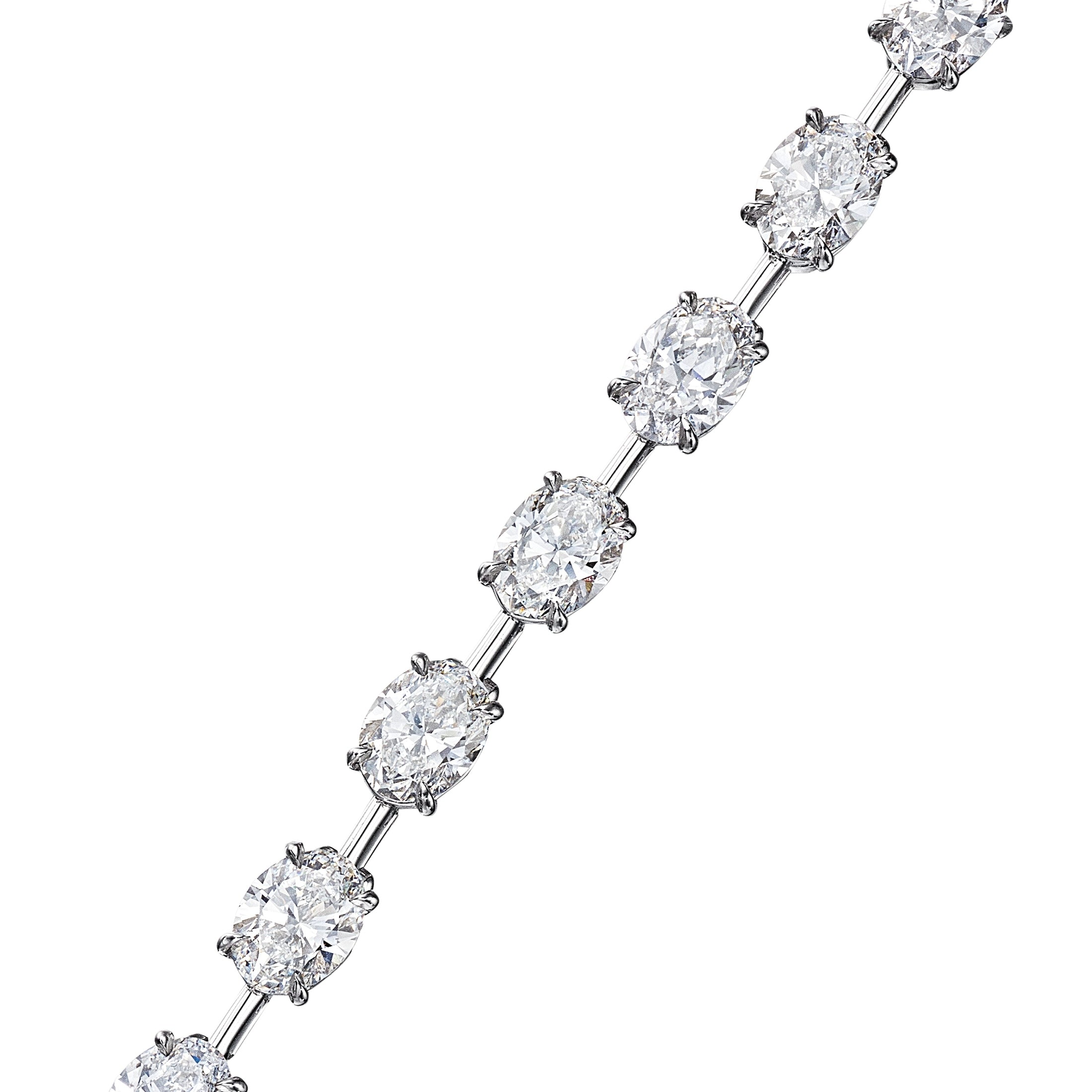 Platinum oval diamond station bracelet close-up with four-prong settings and airy spacing