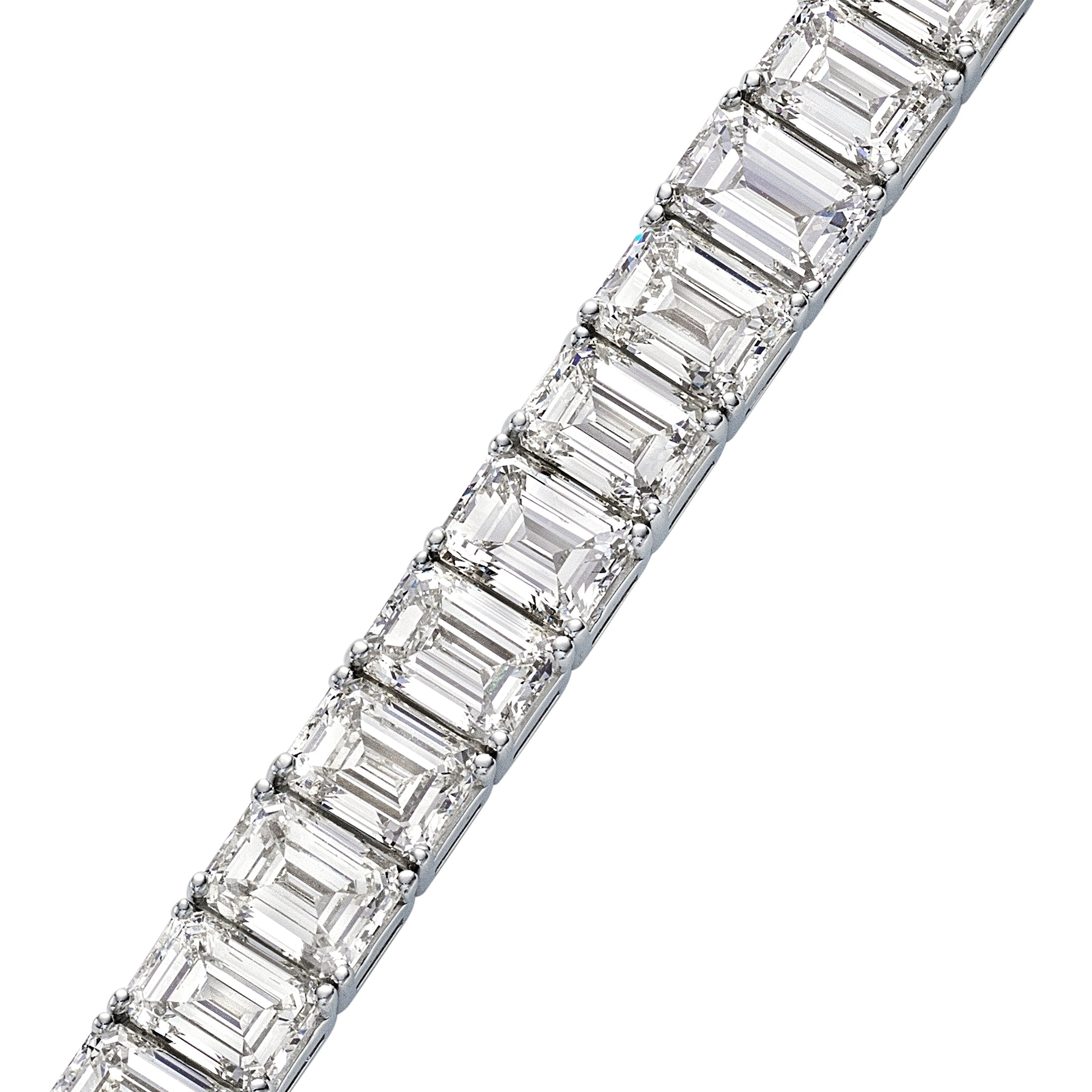 Close-up side profile of channel-set emerald diamonds and polished 14K white gold band