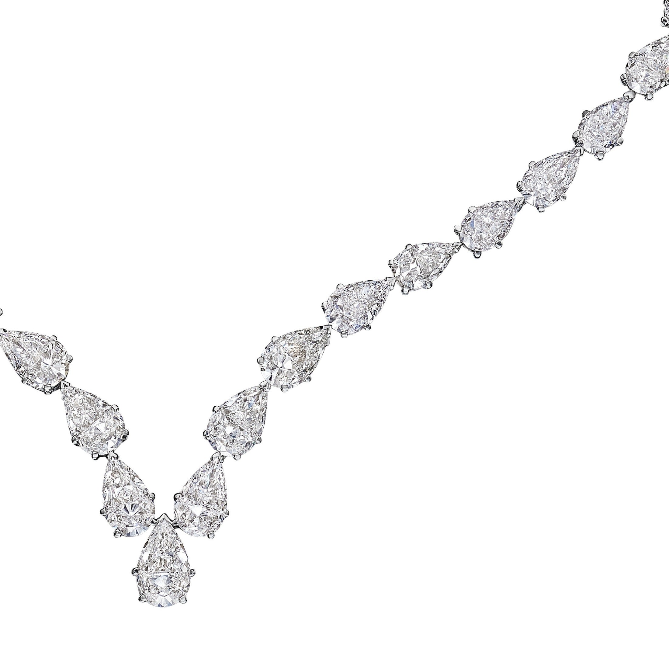Close-up of Leviev pear cut diamonds in 18K white gold with milgrain prong settings