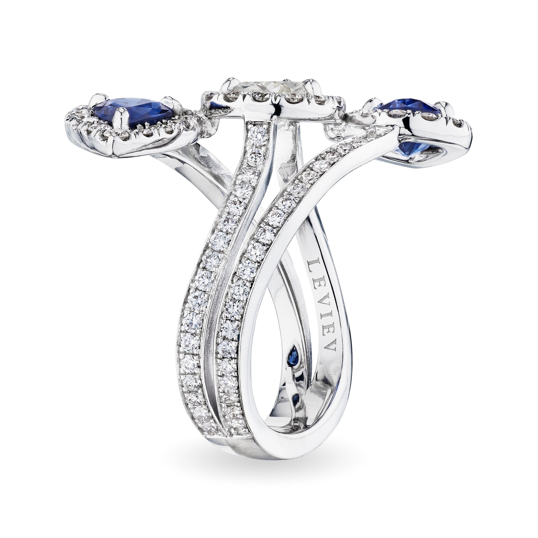 Leviev Reko bypass ring side view with royal blue sapphires, pear diamond halo, and engraved LEVI shank in 18K white gold