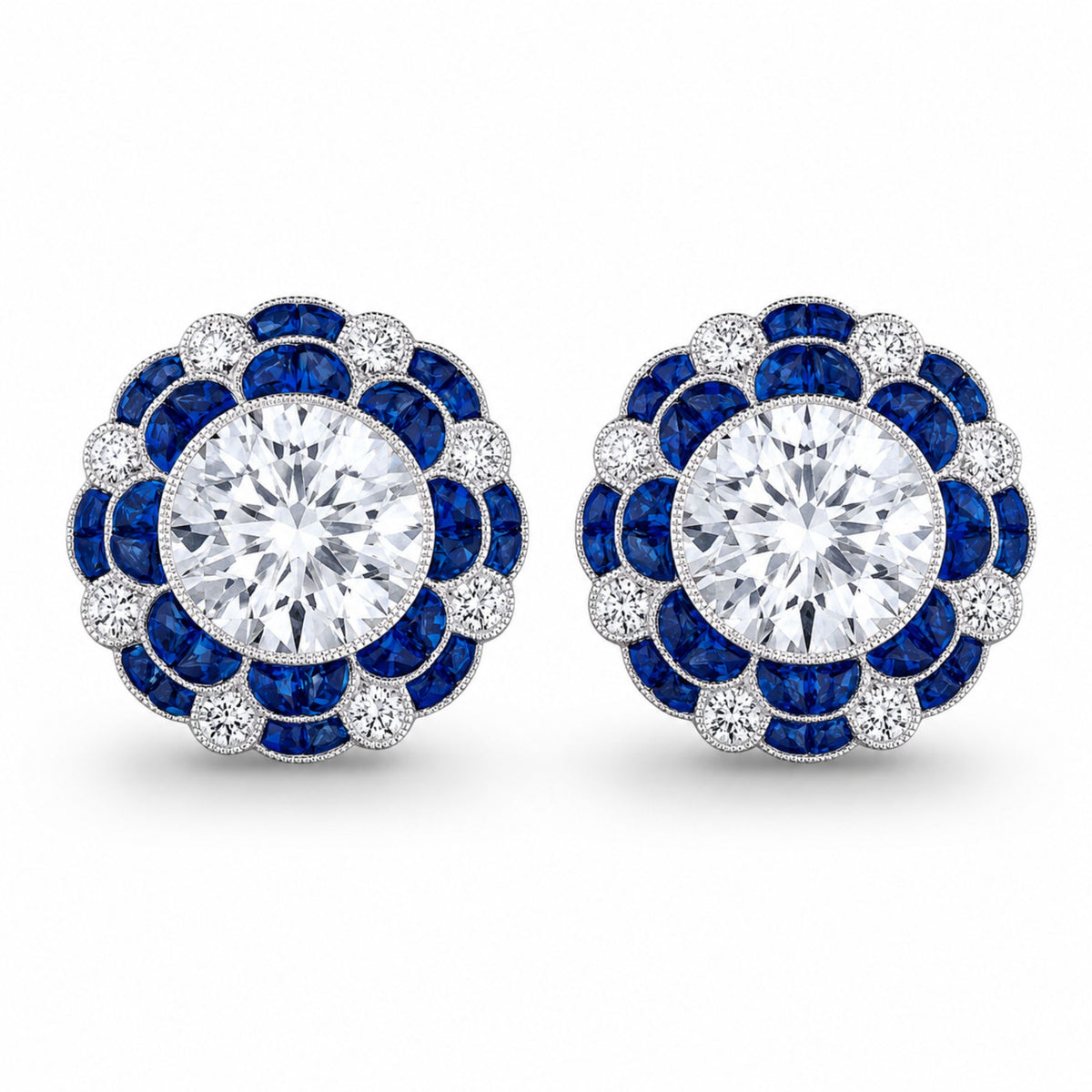 Pair of Leviev Sapphire Blossom diamond stud earrings in 18K white gold featuring royal blue sapphire and diamond floral halo design