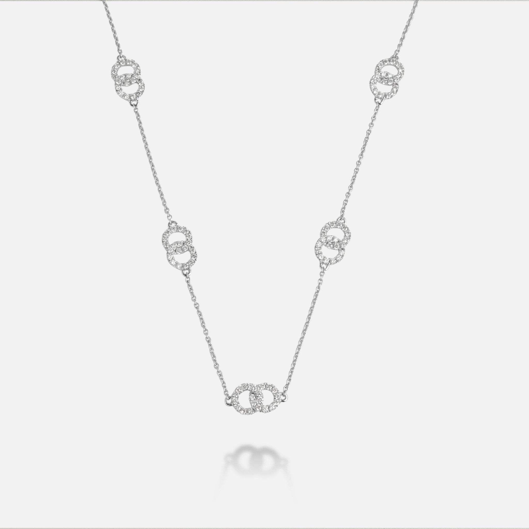 Full length view of Leviev three-motif diamond interlocking ring necklace