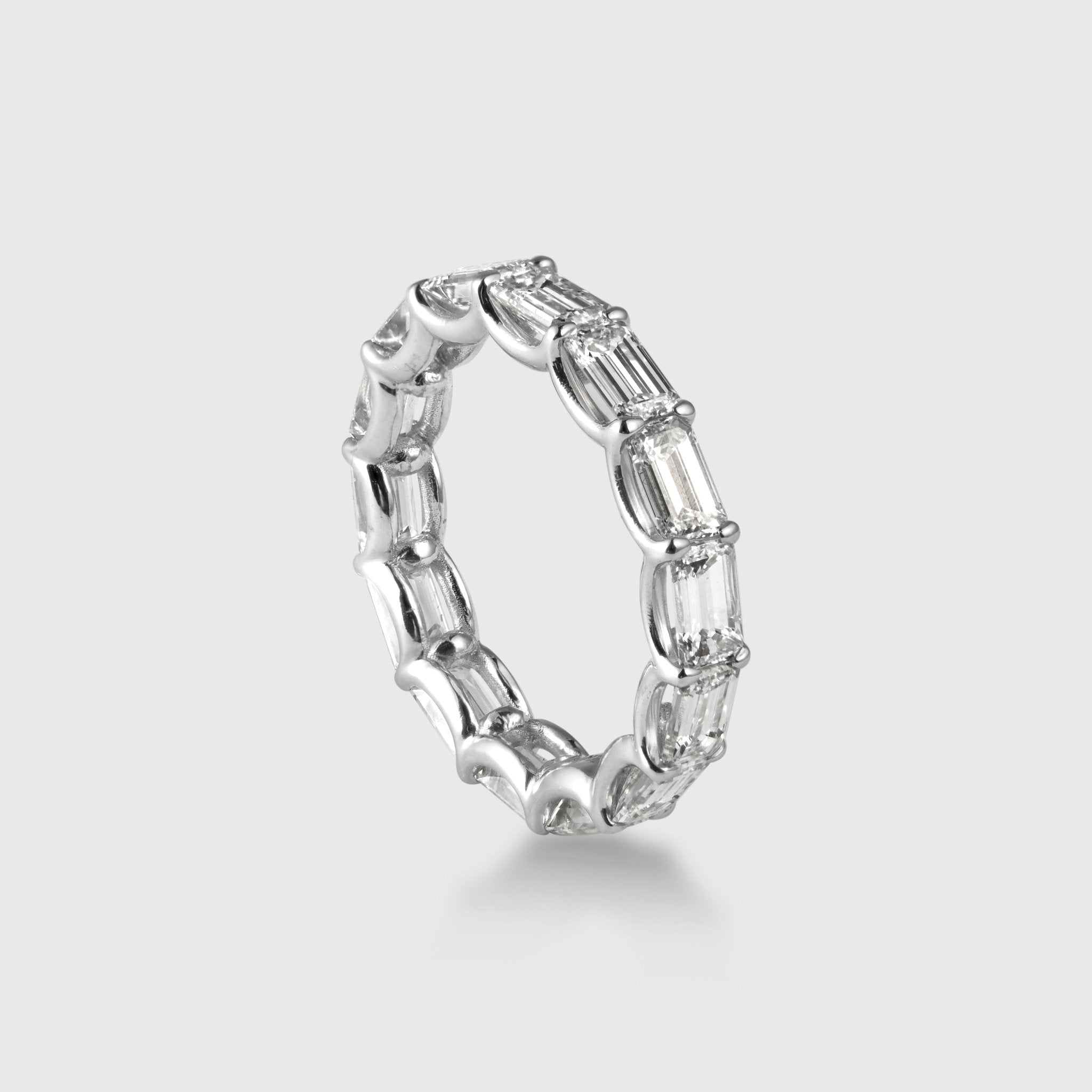 Three-quarter view of Leviev emerald cut diamond eternity band in platinum