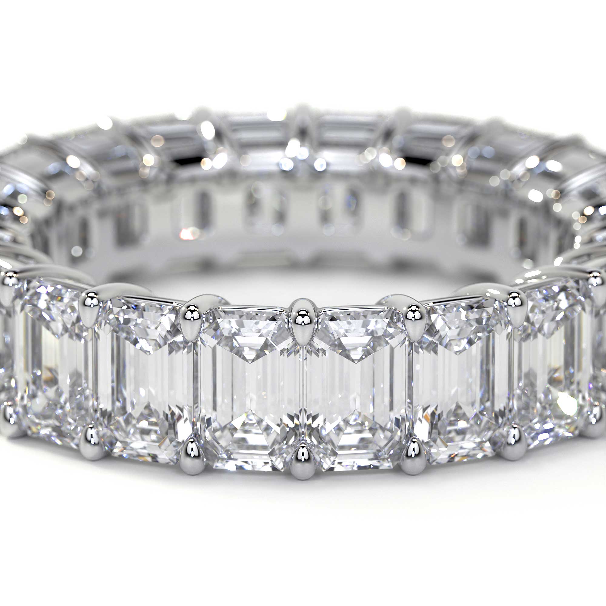 Close-up of platinum emerald cut diamond eternity band facets detail