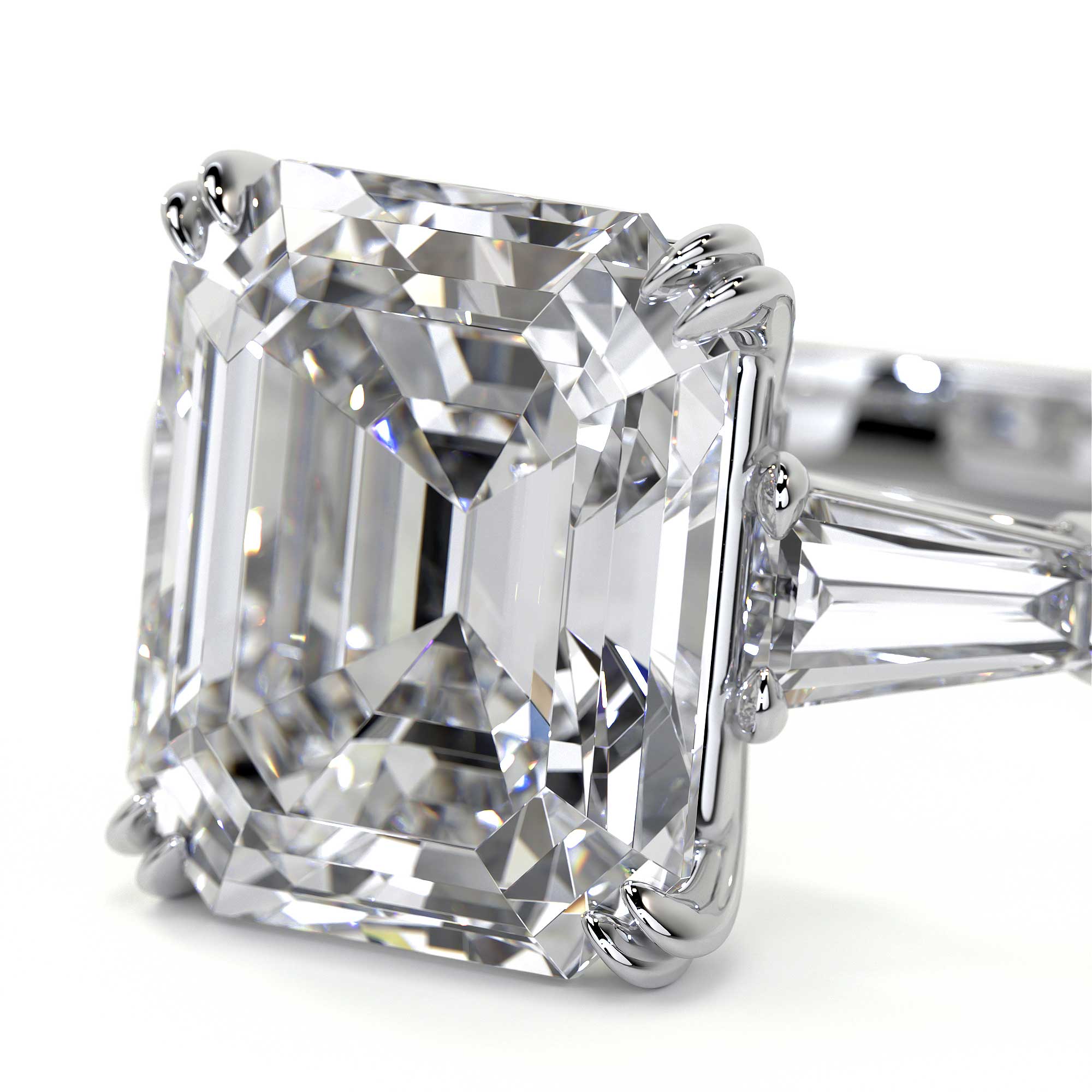 Close-up of emerald cut diamond facets and prong setting on platinum band