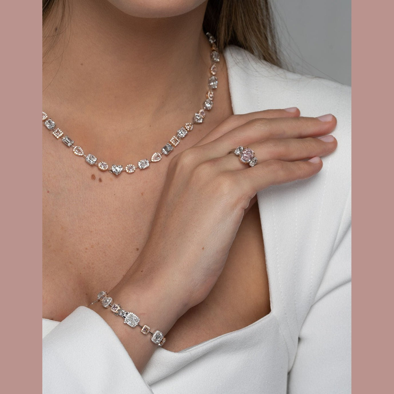 Woman wearing Leviev Orion Nebula pink and white diamond necklace set with matching jewelry