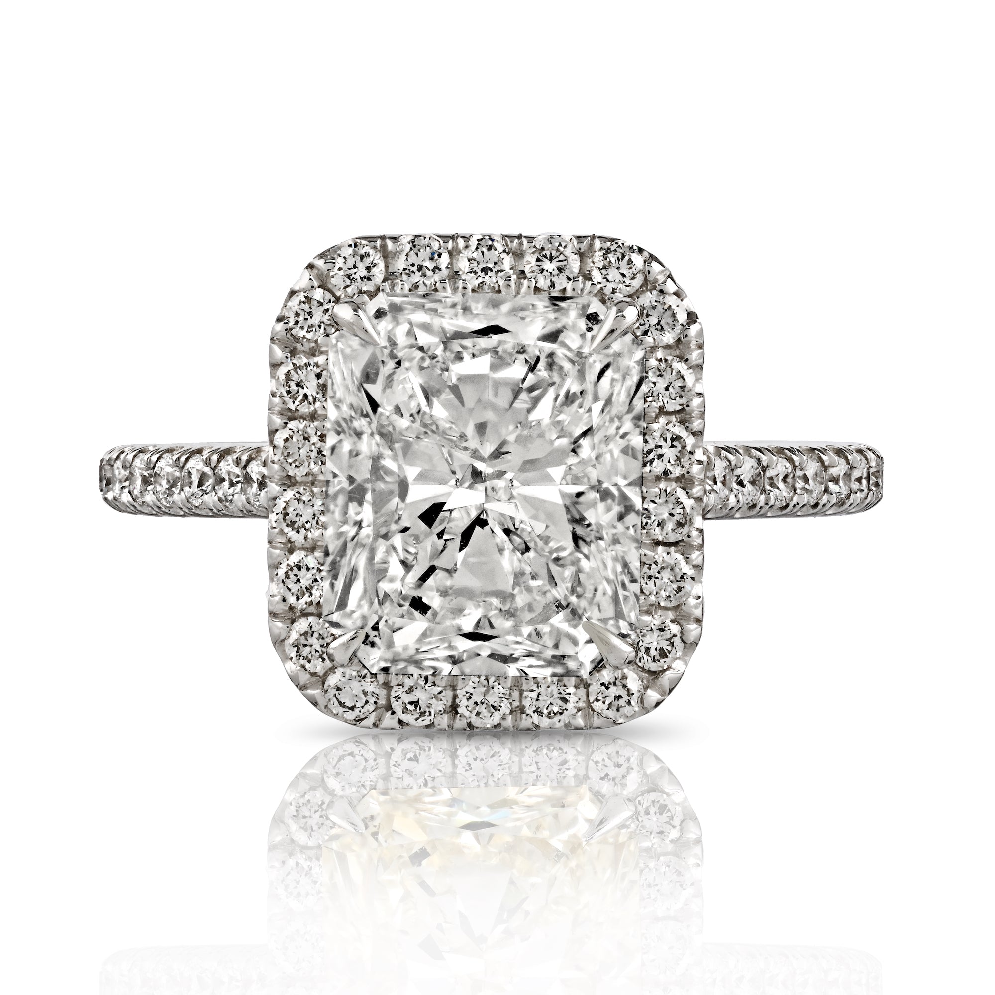 Radiant cut diamond ring with round diamond pave halo in 18K white gold