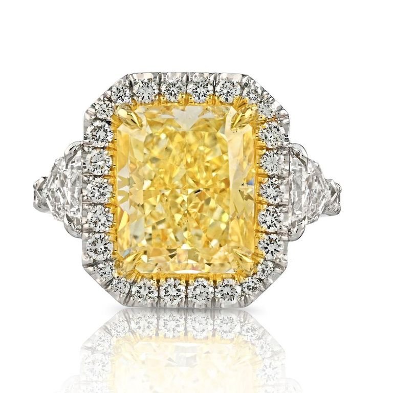 Leviev yellow diamond ring with white diamond halo and shield cuts in platinum